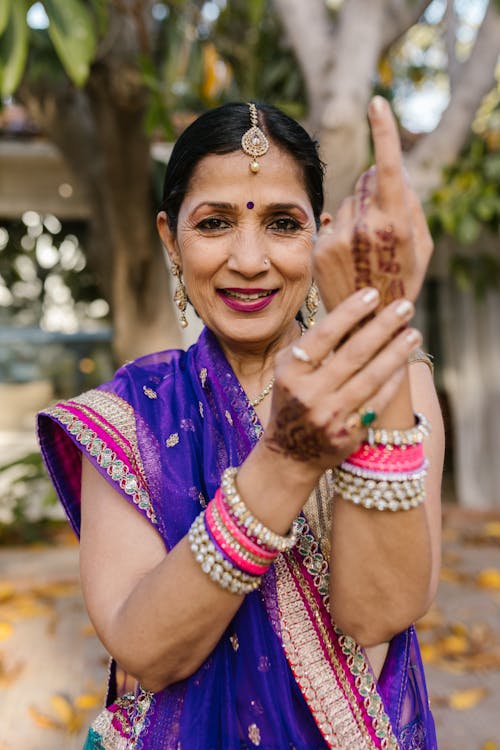 Smiling Woman in Traditional Dress Showing Her Henna Tattoo
