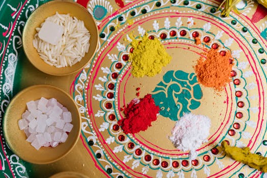 Top view of a traditional festive setup with colorful powders and grains symbolizing a cultural celebration.