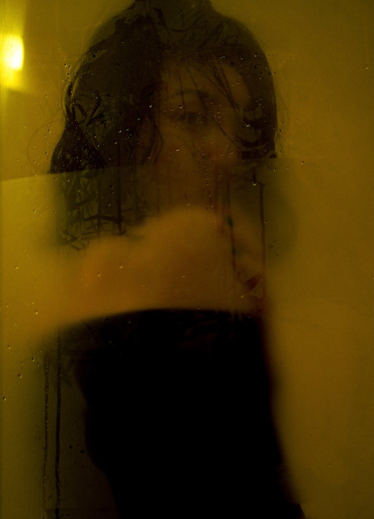 Woman Looking At Camera Through Glass