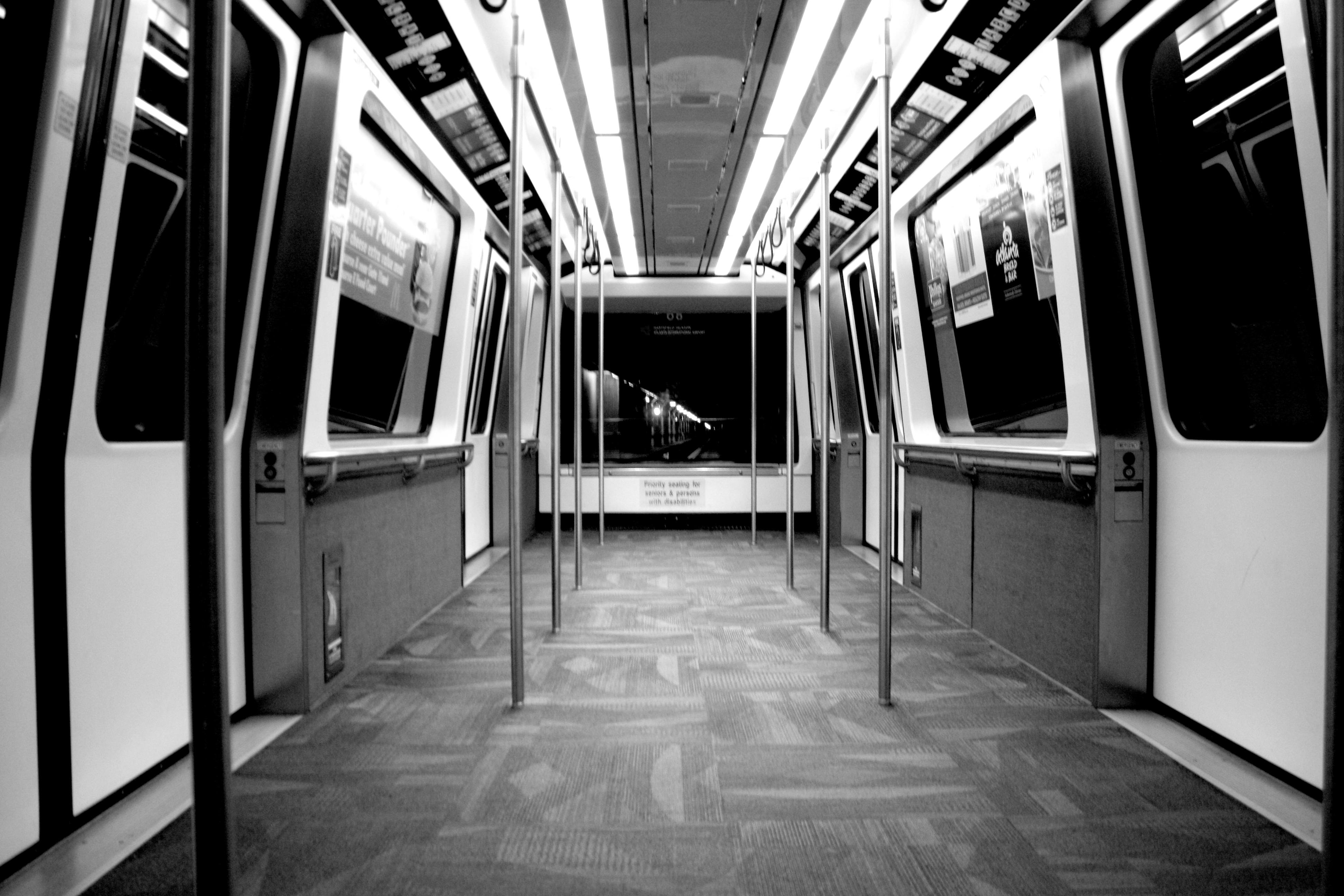 Free Black and white photo of an empty metro train interior emphasizing symmetry and modern design. Stock Photo