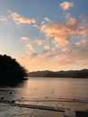 A Body of Water Under Blue Sky with White Clouds