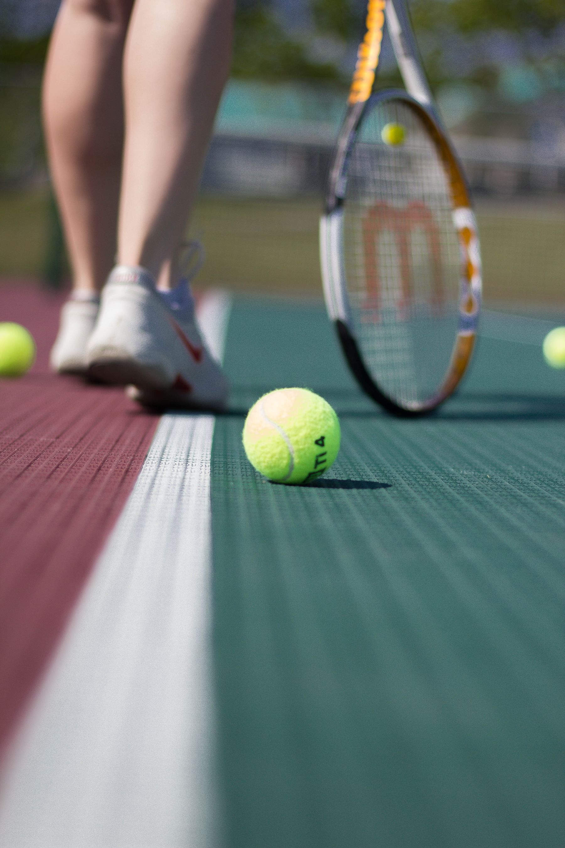 Tennis ball on a clay court surface