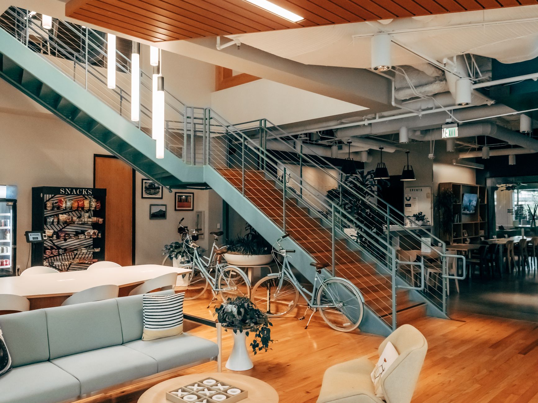 Contemporary shared interior with ceiling lights, sofas, and a meeting area