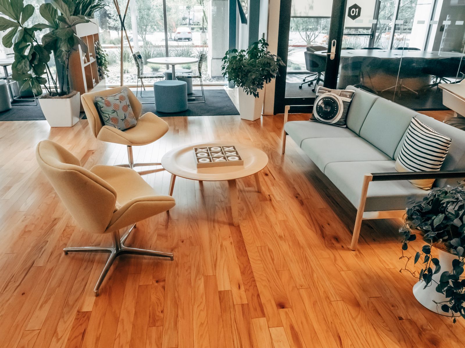 Bright office lounge with warm wood and soft seating — photo by Kindel Media on Pexels