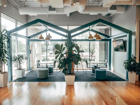 A contemporary office space featuring indoor plants, modern furniture, and natural lighting.