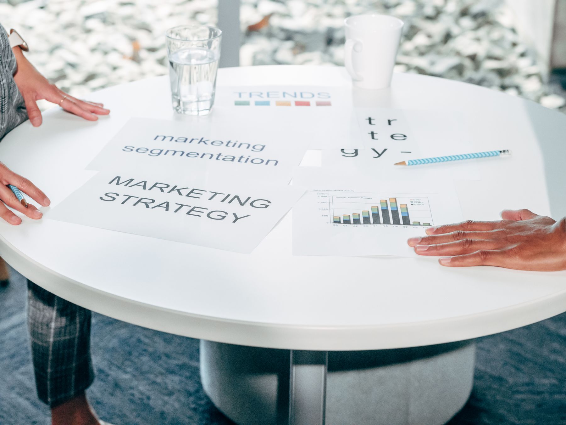 Professionals working through strategy documents at a table