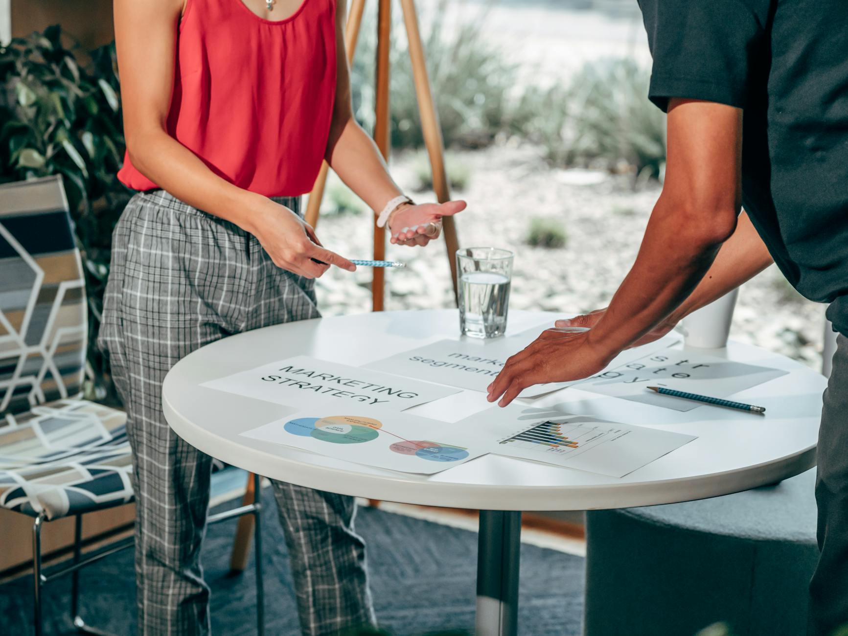 Two colleagues collaborate on marketing strategies at a modern workspace.