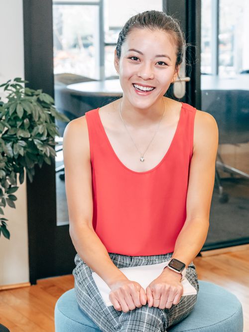 Free Young Asian woman smiling confidently indoors in business casual attire. Stock Photo