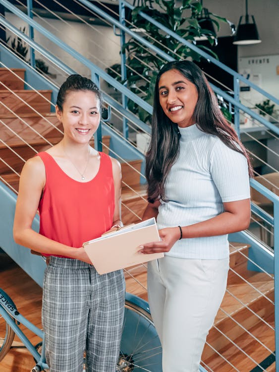 Person looking tired and overwhelmed at their desk with multiple papers