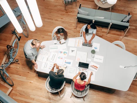 Top view of diverse colleagues having a discussion at a modern office table.