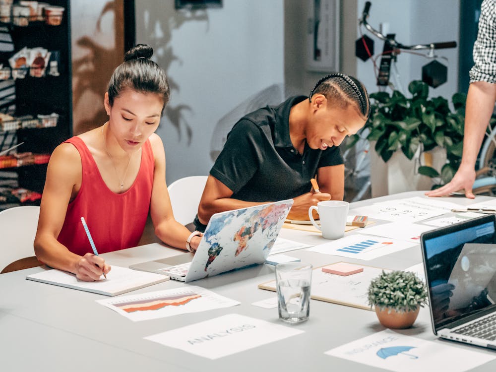 Person looking tired while working on a laptop late at night