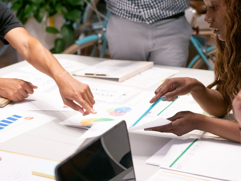 Marketing team collaborating around a desk on client social media content