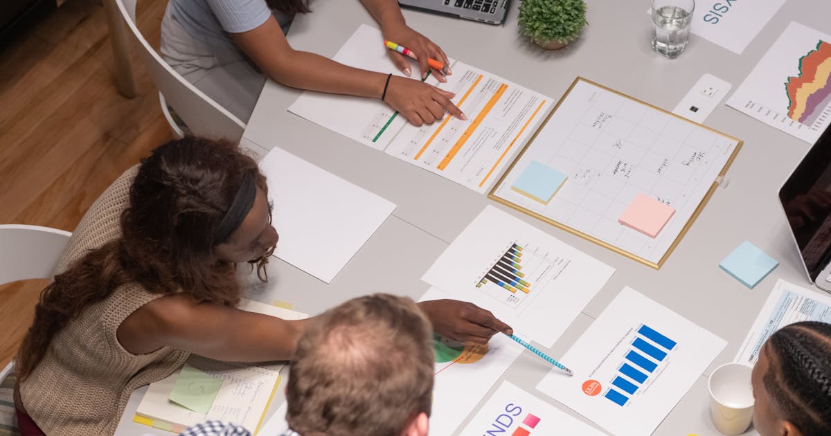 Business professional analyzing financial data and charts on a laptop screen