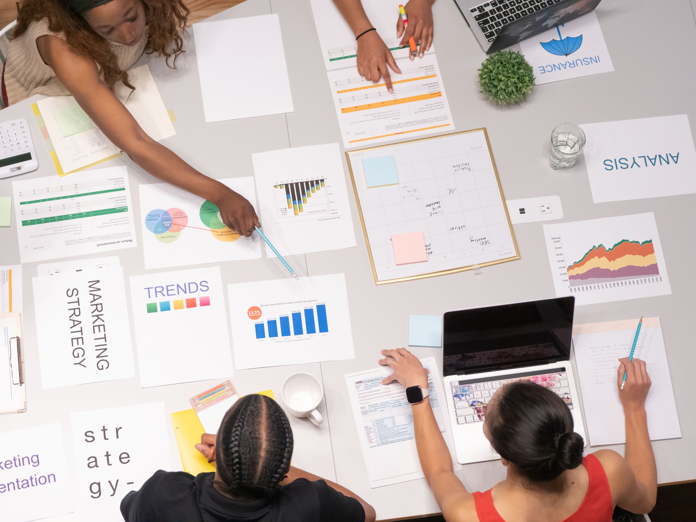 Shopify product page planning notes and ecommerce analytics on desk