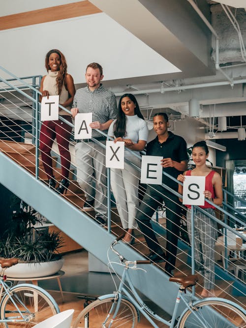 Free Happy Coworkers Standing on a Stairway Stock Photo