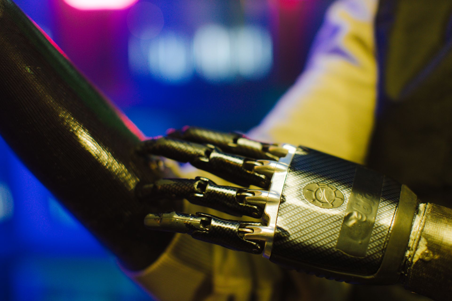 A Person with a Black and Stainless Prosthetic Hand