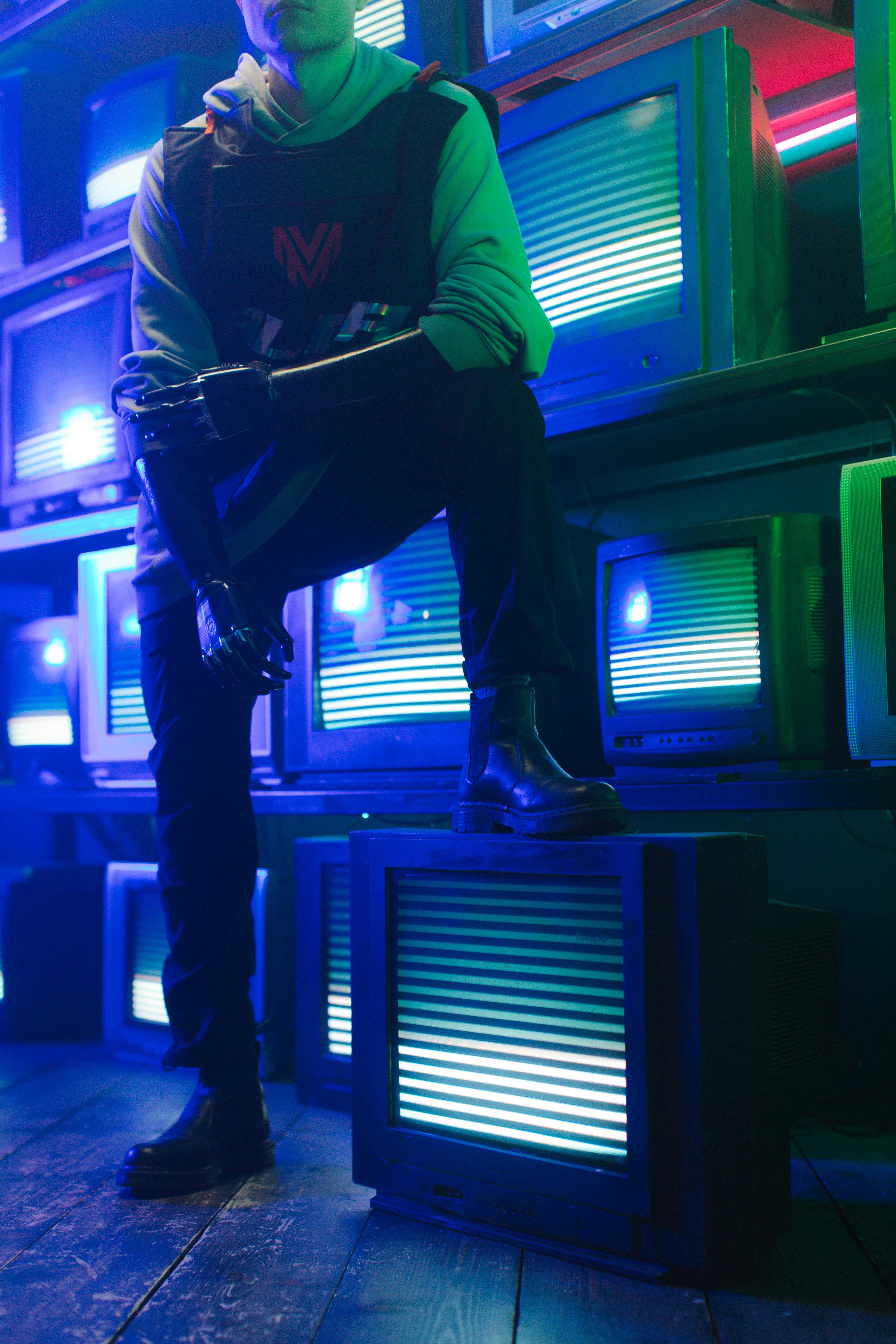 a person with prosthetic arms stepping on a tv with static lines