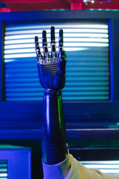 Close-up of a bionic prosthetic arm raised against retro tech background.