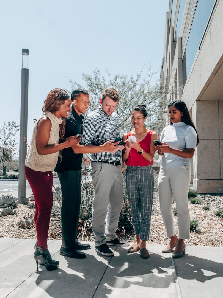 A Group Pf People Holding Smartphones