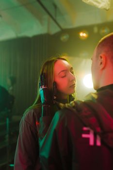 Intimate moment of a couple highlighting technology with a prosthetic arm in a studio environment.