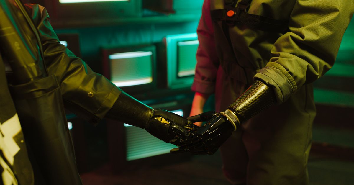 A compelling handshake featuring modern prosthetic arms in an industrial environment.