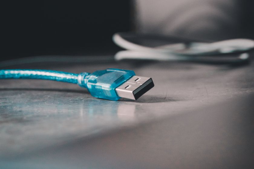 A blue USB-A cable connector on a desk
