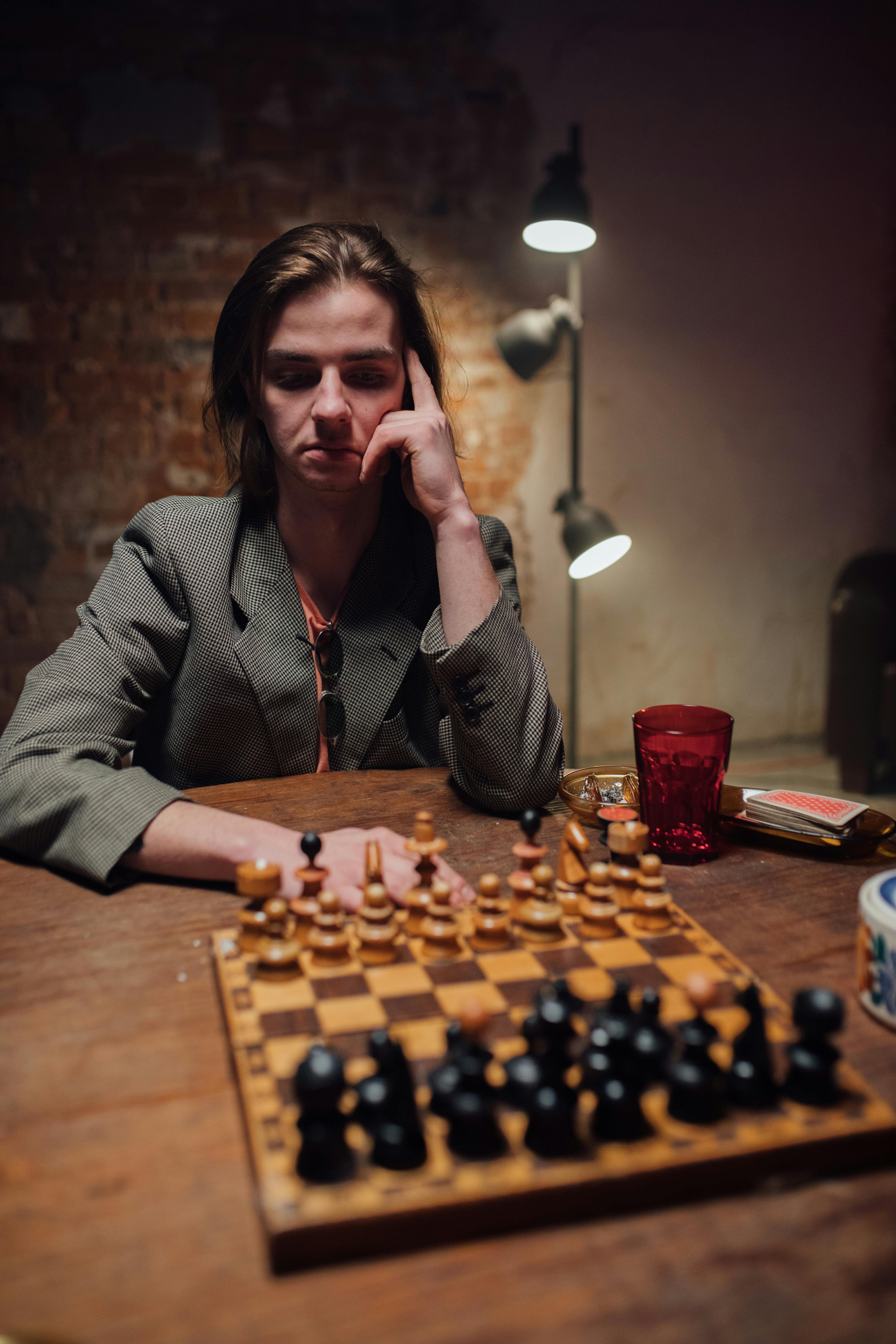 A Man Is Playing Chess Thinking About The Next Move Stock Photo - Download  Image Now - iStock