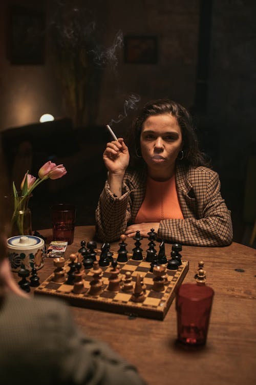 Woman Playing Chess and Smoking Cigarette