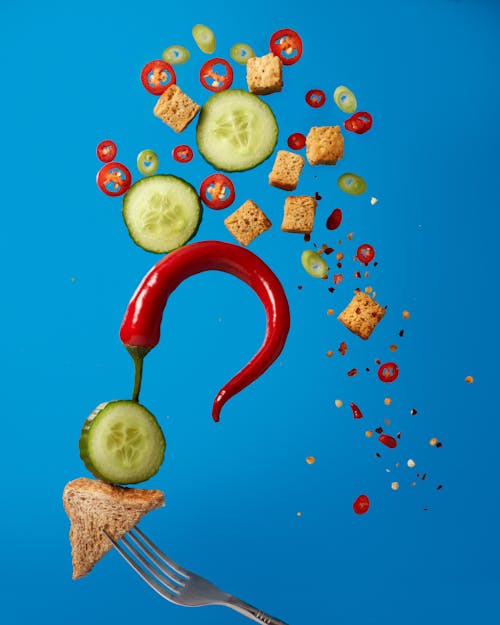 Chili and Cucumber on Blue Background