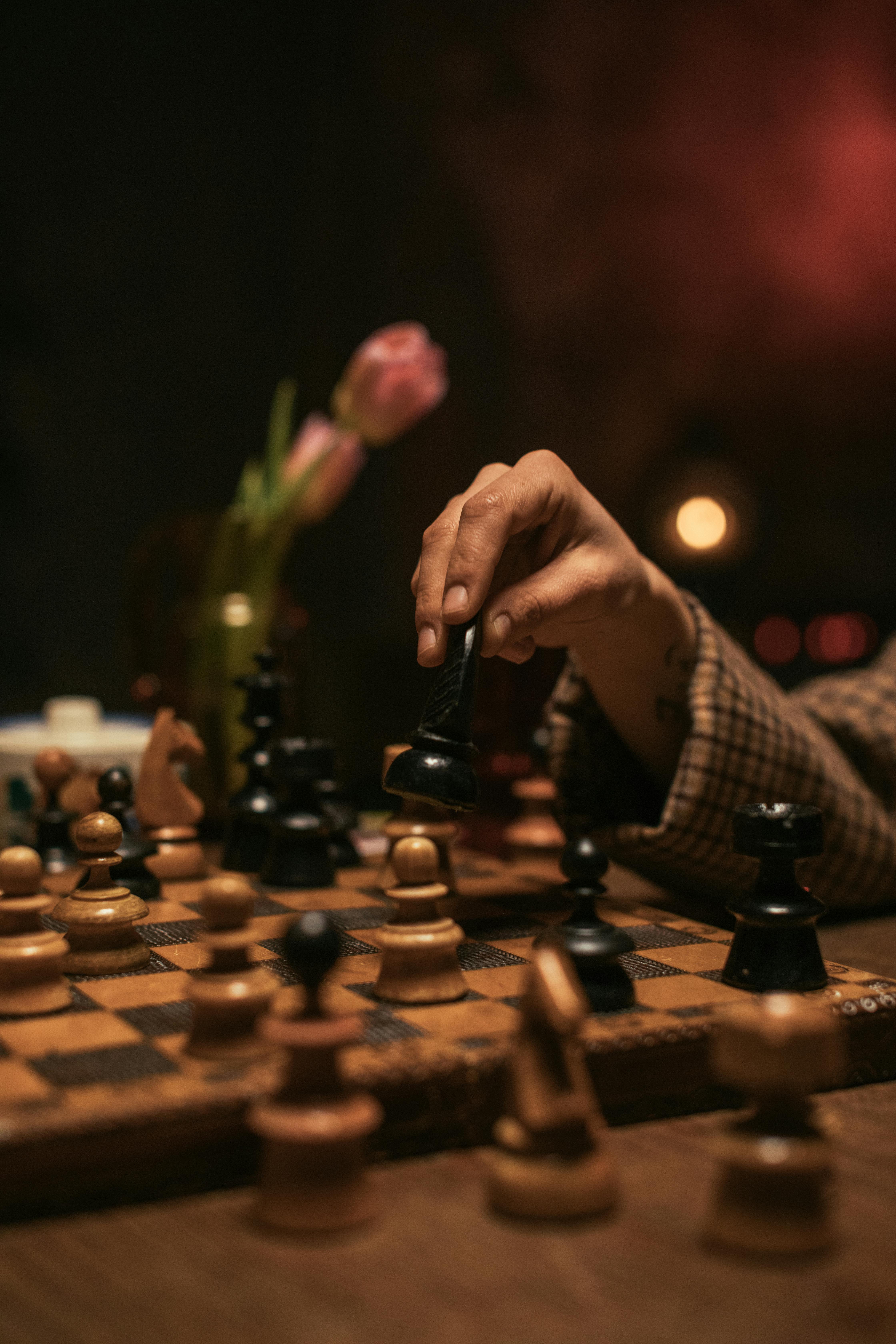 Person Playing Chess Game on Chess Board · Free Stock Photo