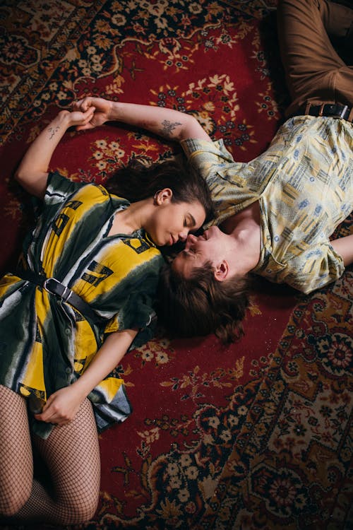 Free A Romantic Couple Lying on the Carpet Stock Photo