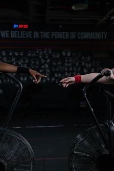 Diverse hands reaching out in a gym, symbolizing community power.