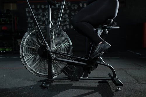 Person in Black Pants Using a Stationary Bicycle