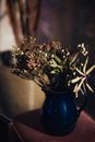 White and Green Flowers in Blue Ceramic Vase