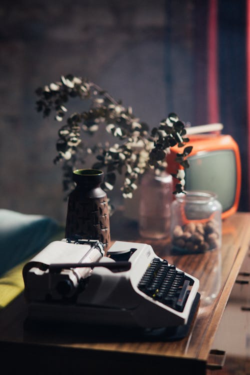 Free Vintage Typewriter and  Television on Wooden Table Stock Photo
