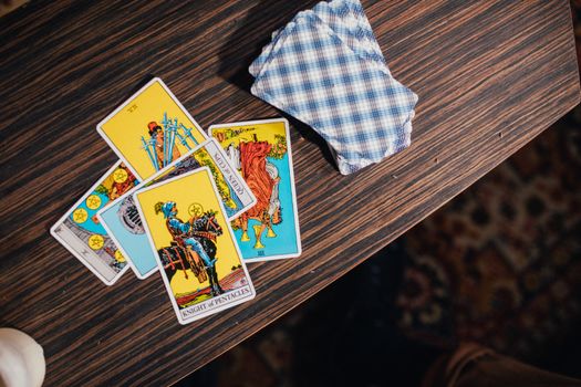Close-Up Shot of Tarot Cards on a Wooden Table