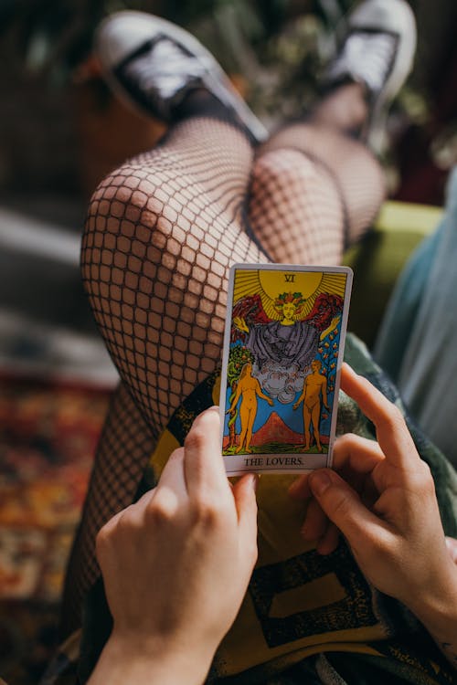 Free Person Holding a Tarot Card Stock Photo