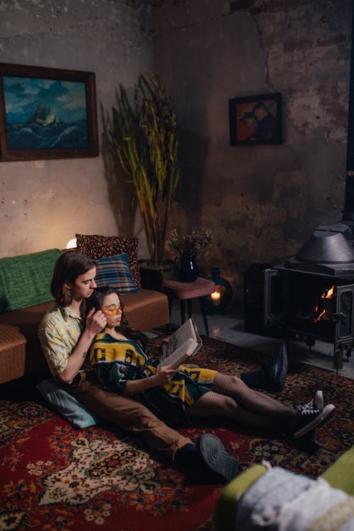 Free A Couple Reading a Book Together Stock Photo