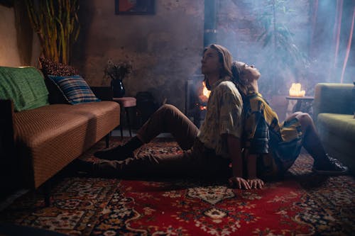 A loving couple enjoys an intimate moment in a cozy, vintage-inspired loft with ambient lighting.