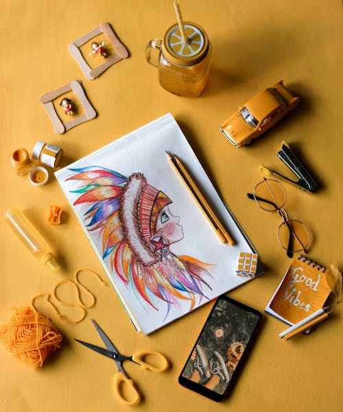 Sketchpad and Art Materials on Golden Yellow Background