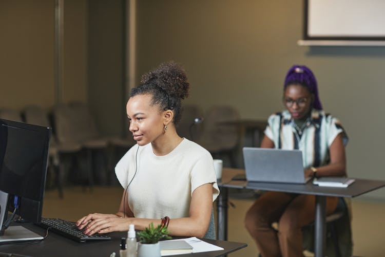 Women Working In Front Of Laptops 