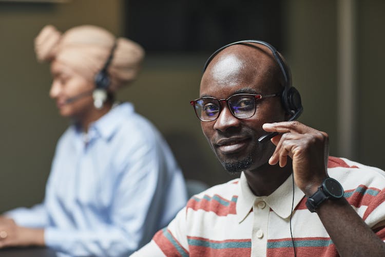 Shallow Focus Of A Man Wearing Eyeglasses And Headphone