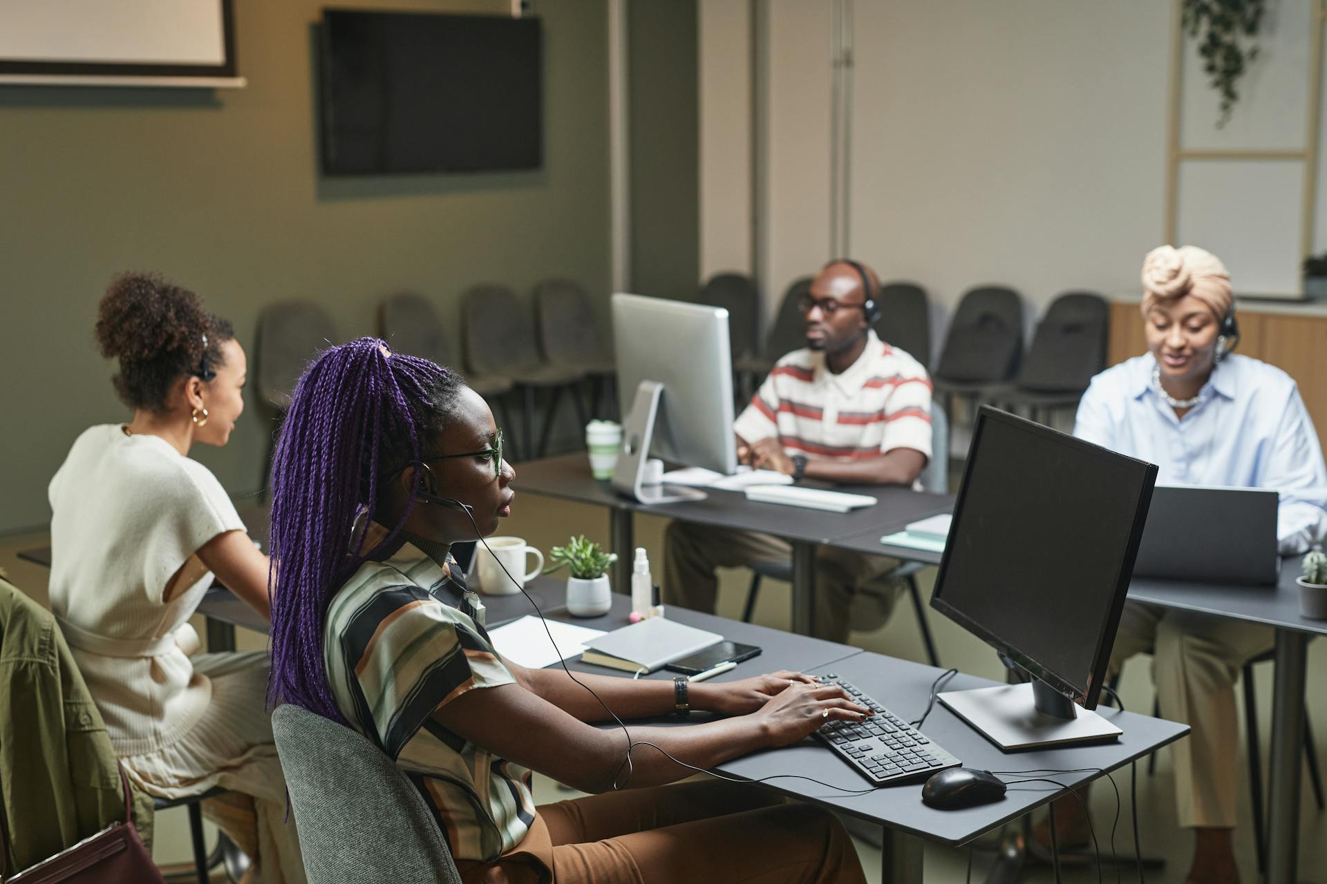 A diverse group of professionals working collaboratively in a modern office setting.