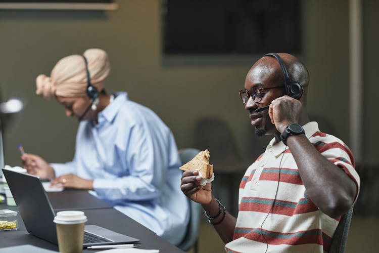 Man Eating Sandwich While Working