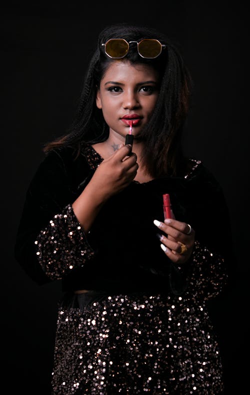 Beautiful Woman Putting Lipstick On 