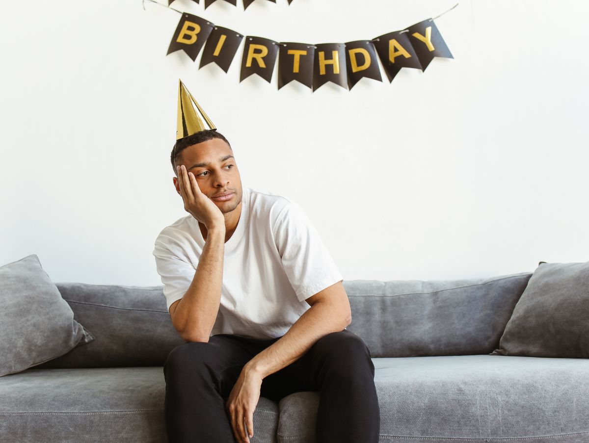 Thoughtful person sitting alone during a social celebration