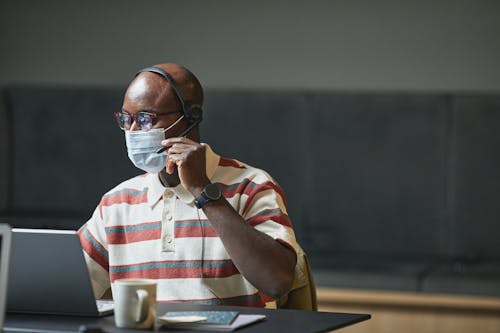 Photo of a Man with a Face Mask Working