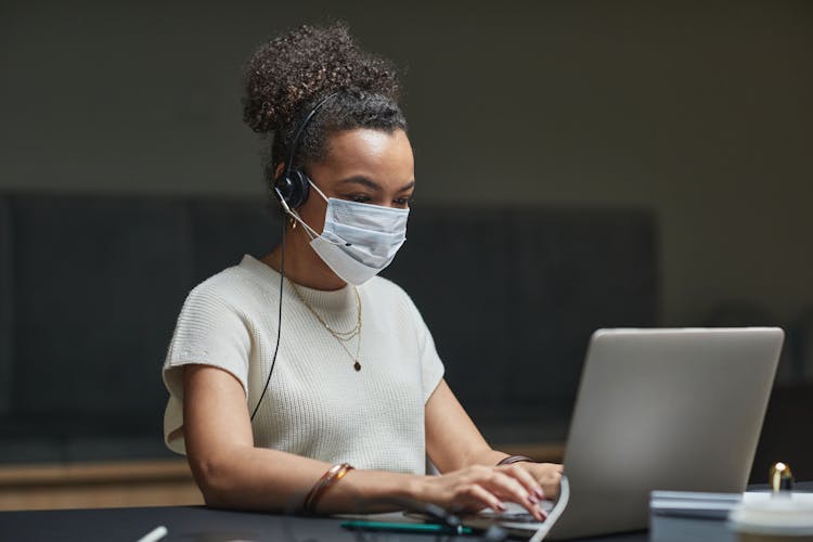 Woman With Headphones Using A Laptop