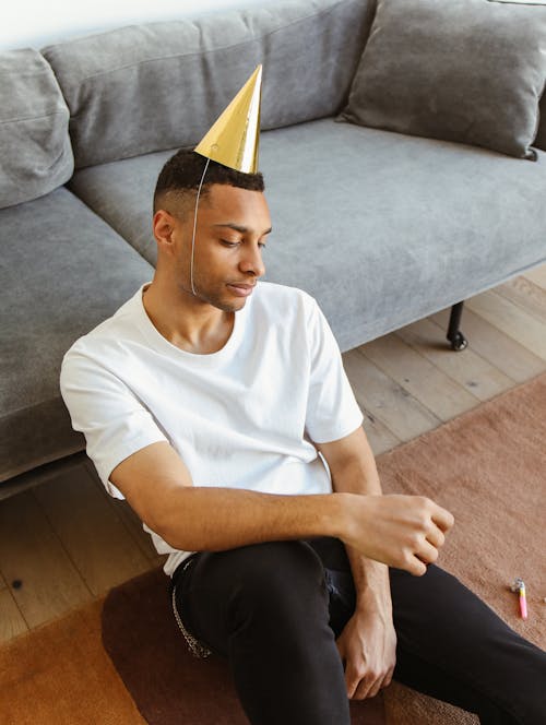 A Sad Man Wearing Party Hat