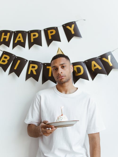 Man in White Crew Neck T-shirt Holding a Plate